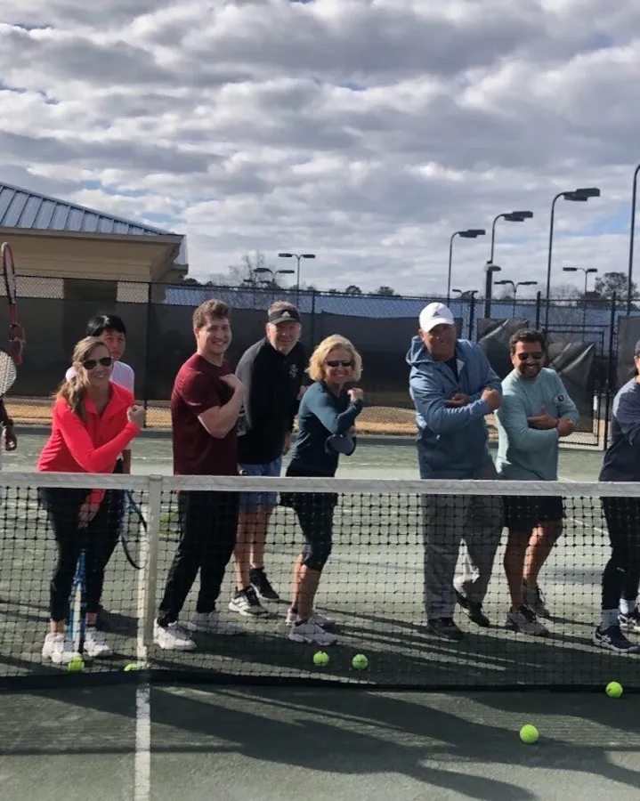 Adult clinic players lined up at the net at Yarbrough